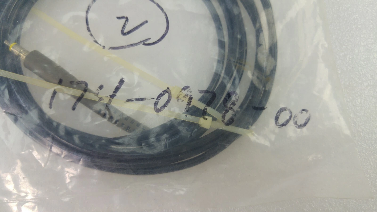 Close-up of a bag hand-marked 174-0978-00 containing a Tektronix probe cable