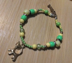Handmade Elastic Bracelet-6 in.-Plastic w/Rhinestone Spacers-2 Goldtone Charms.