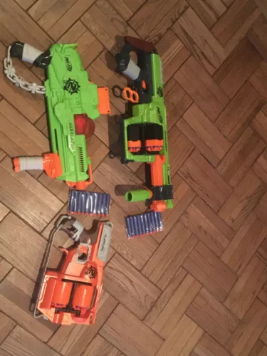 lot of Zombie Strike nerf guns complete with extra darts, clips and 3 guns
