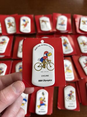 (1)Cycling 1984 OLYMPICS LOS ANGELES SAM OLYMPIC EAGLE BUTTON 24 Different Av.
