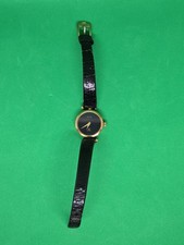 Gucci Woman  s Vintage Watch. Gold Tone case/dial on black face. DOES NOT RUN