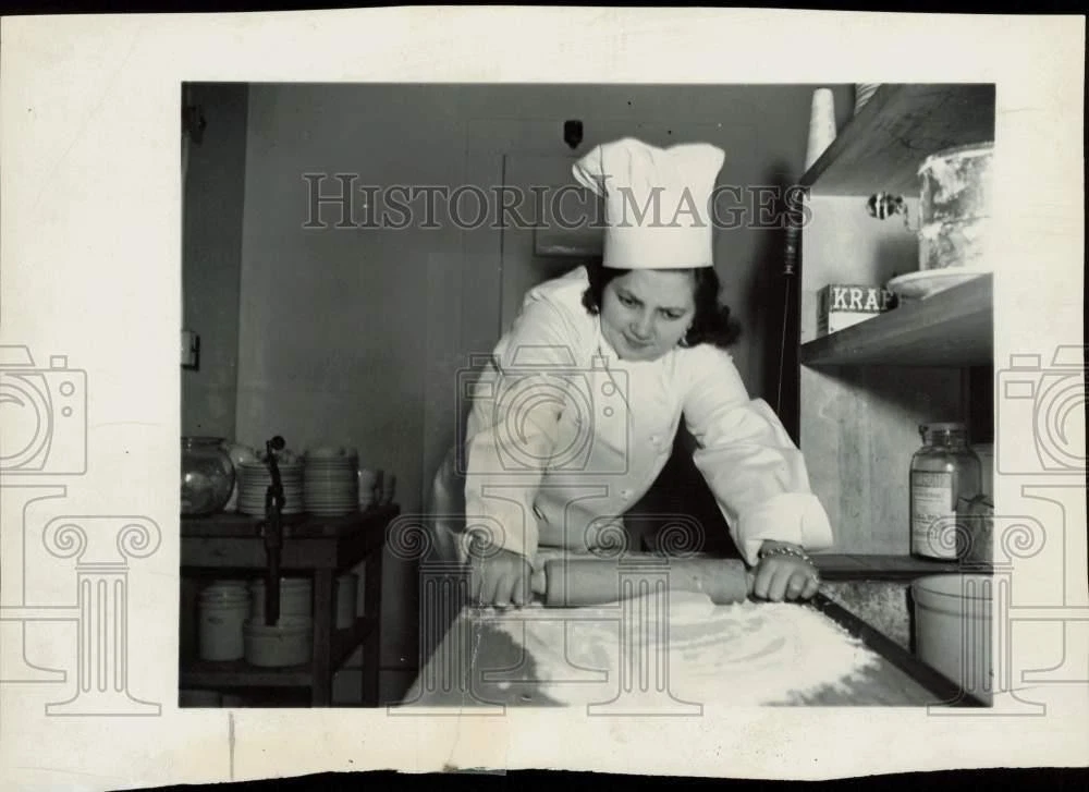 Press Photo Baker rolling dough with a rolling pin - lra46506