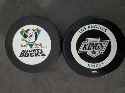 Lot (2) LA Kings & Anaheim Mighty Ducks Official Licensed Hockey Pucks