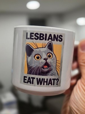 Ceramic Cat Novelty Coffee Mug with 'Lesbians Eat What?' Text, Multicolor