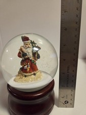 Santa Claus musical snow globe, Santa rotates while O Christmas trees plays