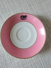 O.P.Co.  pink rimmed saucer w/ bull  in black -pre Syracuse China