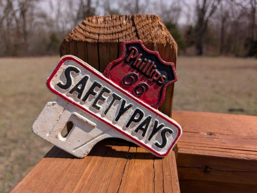 CAST IRON PHILLIPS 66 SAFETY PAYS OIL GAS CAR AUTO LICENSE PLATE TOPPER