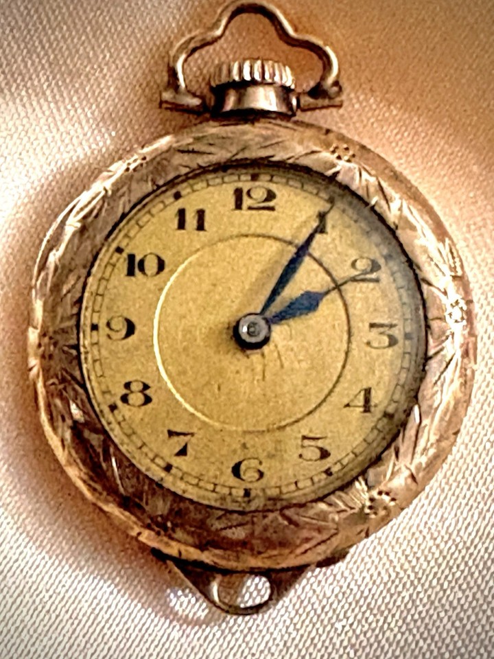 A Swiss 15-jewel pendant pocket watch in a Wadsworth 20-year gold-filled case — the kind of delicate, ornate piece that feels like a found family heirloom.