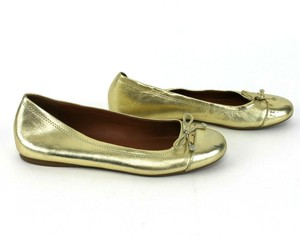 coach gold ballet flats