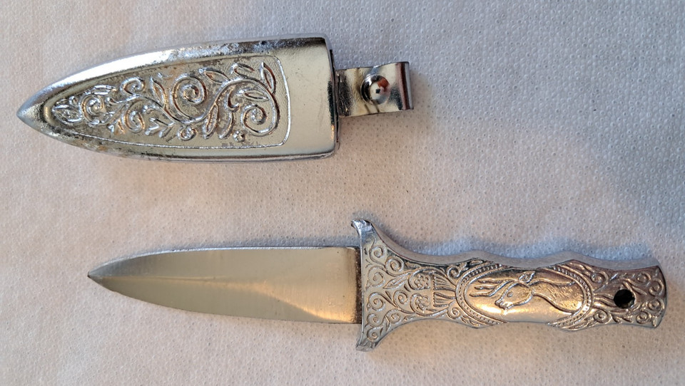 An engraved stainless steel MCM letter opener with a deer buck motif — sharp, handsome, and completely at home on a rustic or retro desk.