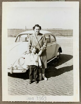 Woman and Small Child Standing Posing in front of VW Bug on Beach 1963