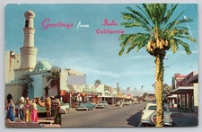 Postcard Indio California Greetings Street View Old Cars Camels Palm Vtg 
