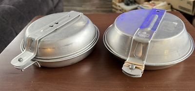 BOY SCOTS AND OR GIRL SCOTS MEN OR WOMEN CAMPING EATING UTILITIES POTS PANS