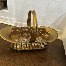 8 Moroccan Berber Moorish gold tea glasses in a brass carrier basket.
