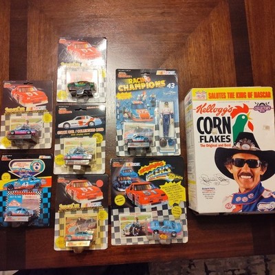 Lot Of 8 Richard & Kyle Petty Collector Items: Die-Cast Cars, Figure, Cereal Box