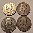 Franklin half dollars, one 1951, two 1952, one 1957...