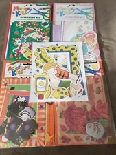 Four Amscan Accessory kits and one Frame-ups kit. Xmas, Fall, Halloween, & baby.