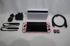 Nintendo Switch OLED in White (Model HEG-001) with accessories and 2 Games.