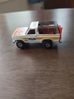 Vintage 1980 Hot Wheels White Ford Bronco With Red Motorcycle on Tailgate.