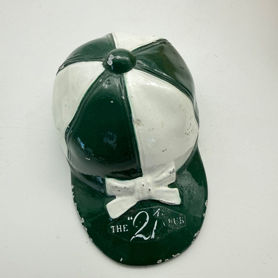 An actual cast-metal jockey-cap bottle opener from New York's legendary 21 Club — a piece of restaurant history you can actually use.