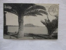 Old postcard ALPES MARITIMES 06 LE FORT CARRÉ ET ANSE ST ROCH SEEN THROUGH PALM TREES