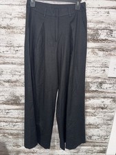 NWT Black pleated wide-leg pants feature front pockets and a high-waisted design
