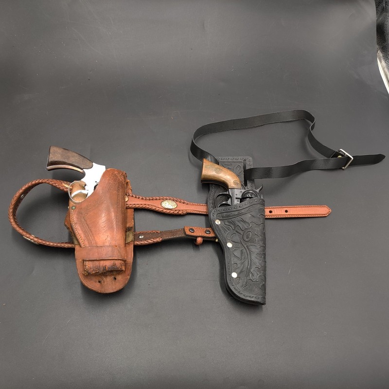 2 toy cap pistols with holsters and belts
