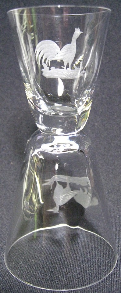 A hand-etched glass double jigger with a rooster motif — a genuinely elegant, one-of-a-kind bar tool that doubles as a display piece.