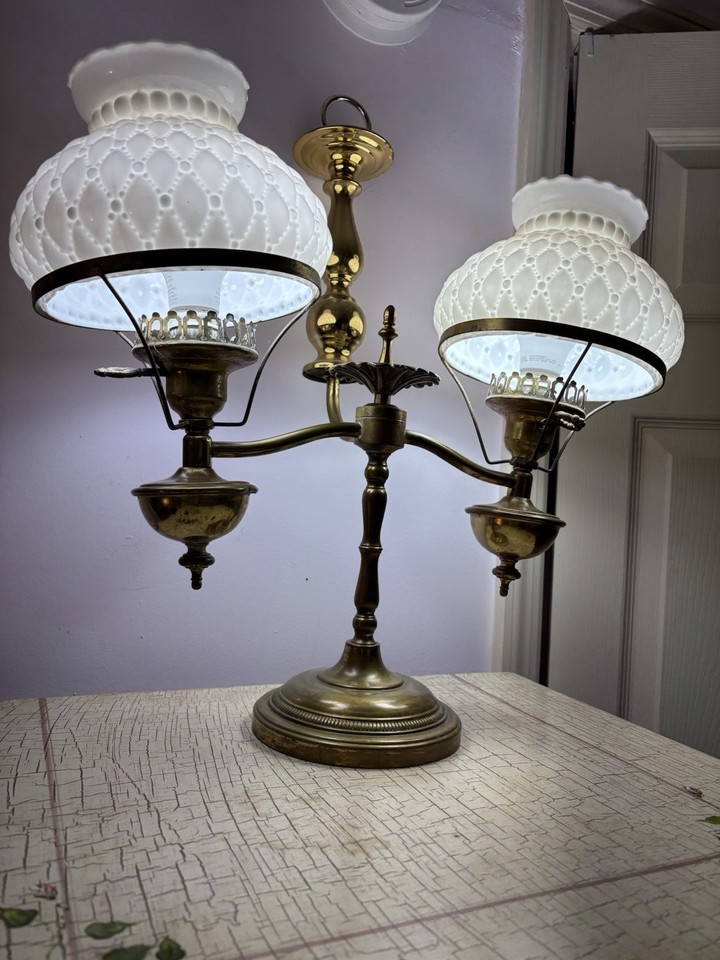 A refurbished antique twin-arm desk lamp — the kind of architectural lighting piece that makes a home office look like a 1930s newsroom.