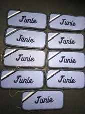 "Junie" (9) Cloth Embroidered Uniform Name Tag Blue on Blue. Lot #209