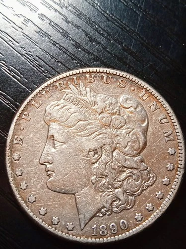 1890-CC Morgan silver dollar. Nice VF. Silver gray. Minor ding. No reserve.