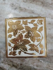 Vintage Powder Compact Gold Flowers displayed on a white enamal top Rex 5th Ave