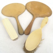 Four art deco xylonite items two Hand held mirrors, Hair Brush & Clothes Brush