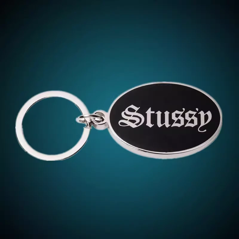 VINTAGE RARE PORTE CLÉS BADGE STUSSY O.E ​ Créatif Alliage Métal Carhartt Suprême