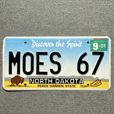 North Dakota Vanity License Plate MOES 67 Personalized Embossed 2001 Tab Tag