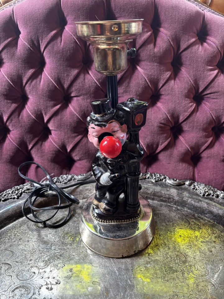 A ceramic hobo bartender with a glowing red nose — equal parts vintage kitsch and fever-dream conversation piece.