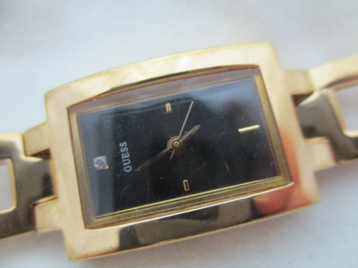 Gold guess watch top with black face