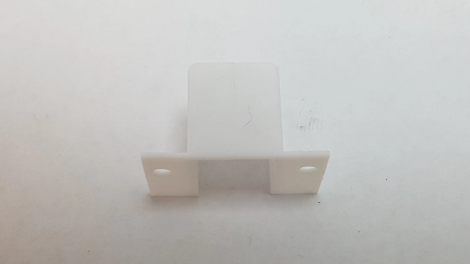 White Lumenis anode cover, front view showing the two flanges and holes