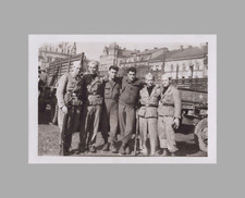 WW2 Photo U.S. Group GIs By Military Vehicles City Buildings In Back
