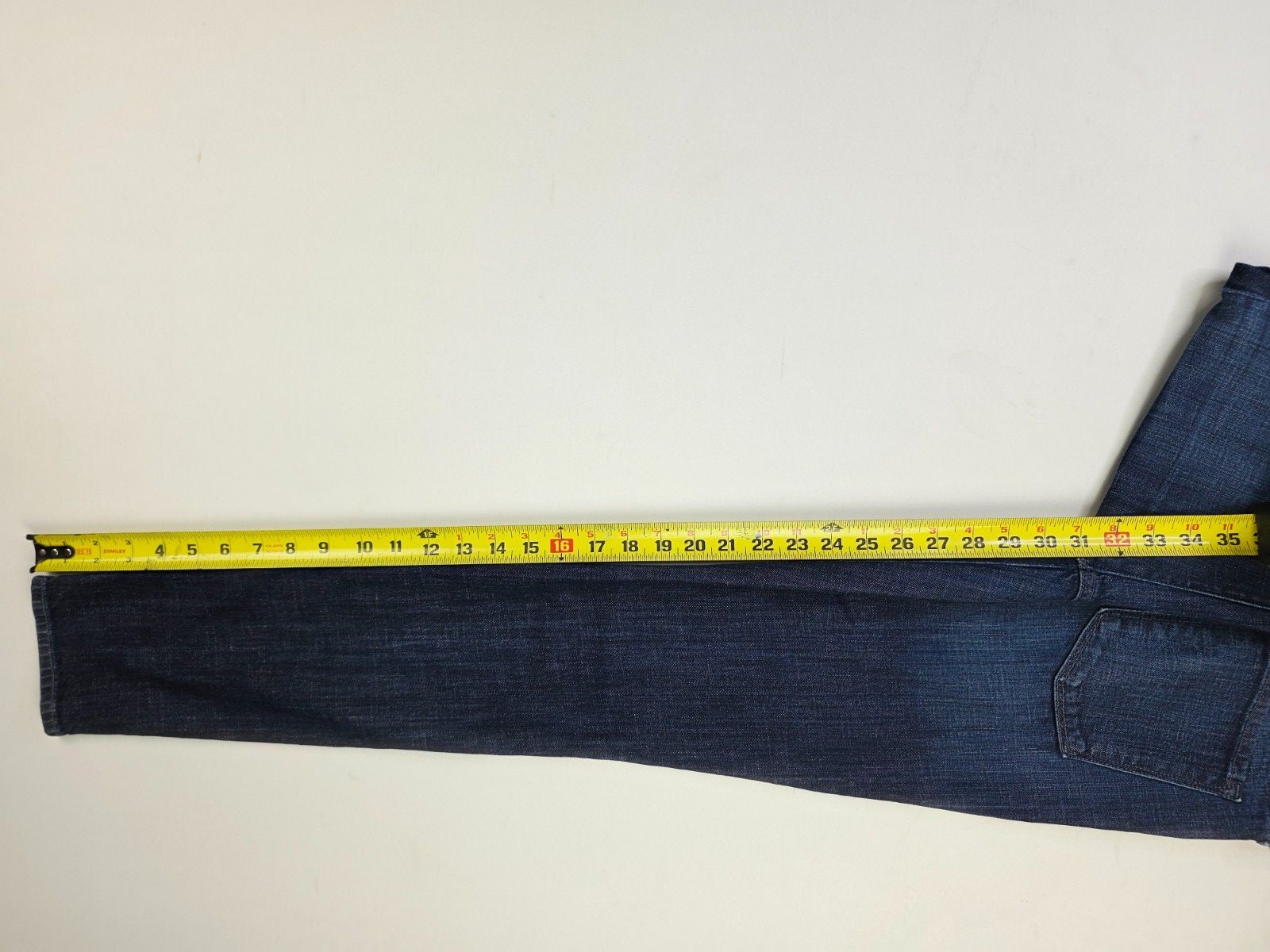 Vince Dylan skinny women’s 28X31 blue denim 5-pocket jeans with yellow measuring tape across the waistband.