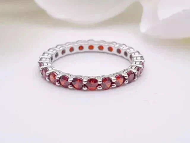 Anillo de banda para mujer de granate rojo creado en laboratorio de corte redondo de 1,5 quilates enchapado en oro blanco de 14 quilates Foto 2 de 4