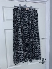 Tu woman's black and white animal print pleated midi/maxi skirt.