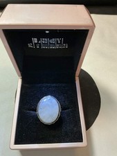 sterling silver ring featuring an oval-shaped Rainbow Moonstone gemstone.