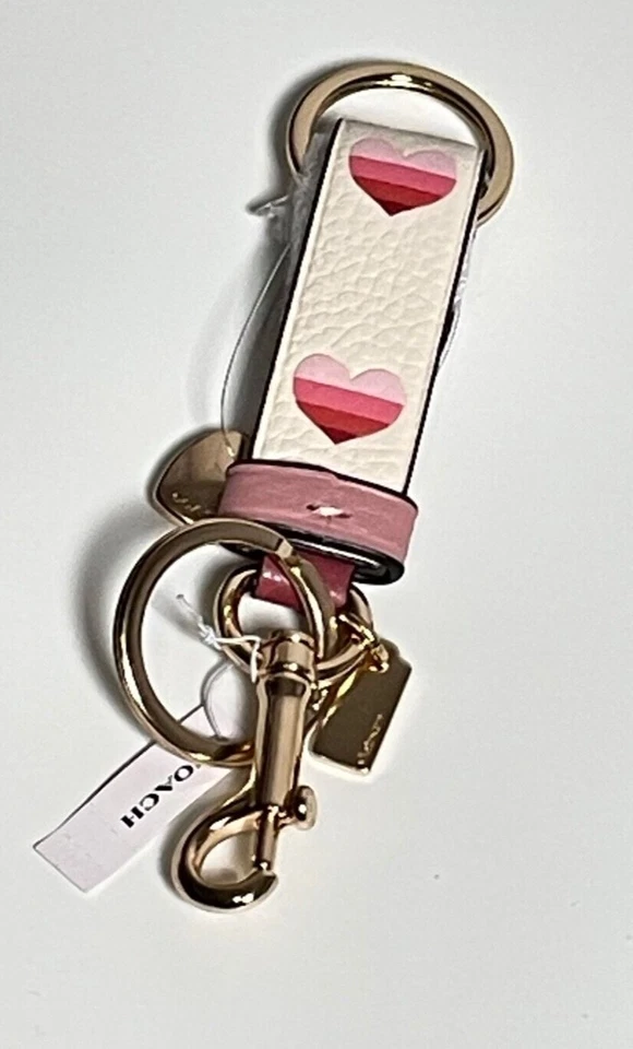 Dije de bolso Coach Trigger a presión con estampado de corazón a rayas CA049