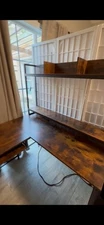 L-shaped office desk with built in shelves, power outlets, and set of drawers