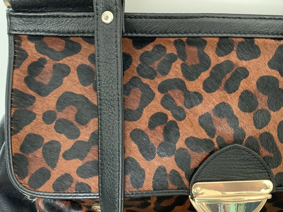 Cartera de cuero suave negra de latón con estampado de leopardo caramelo Aqua Madonna Foto 2 de 4