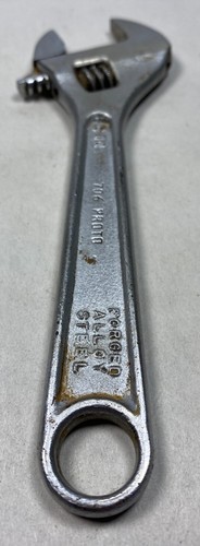 Silver 6" adjustable crescent wrench with worn handle, engraved “706 PROTO TOOLS FORGED ALLOY STEEL” on side.
