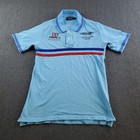 Light blue Hackett London polo shirt with red and red stripe, buttoned cuffs, and embroidered Aston Martin Racing Team logo.