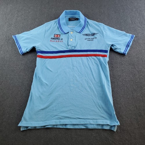 Light blue Hackett London polo shirt with red and red stripe, buttoned cuffs, and embroidered Aston Martin Racing Team logo.