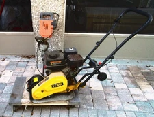 Compactor machine for prepping paver walkway. 